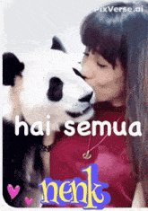 a picture of a woman kissing a panda bear with a caption that says " hai semua "
