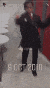 a blurred image of a man in a suit with the date 9 oct 2018 on the bottom