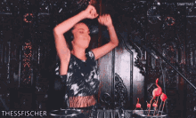 a woman wearing headphones is dancing in front of a microphone and the words thesisfischer are on the bottom right