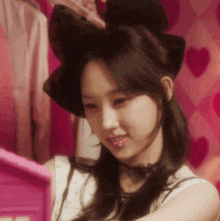 a close up of a woman wearing a cat ear hat and choker .