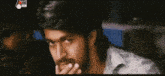 a man with a beard is covering his mouth with his hand and the word amanda is on the bottom