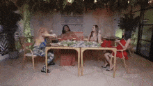 a group of women are sitting at a table with a watermark that says ' abc ' on it