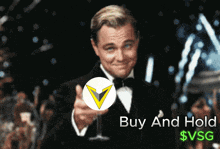 a man in a tuxedo is pointing at a coin with the words buy and hold $ vsg below him