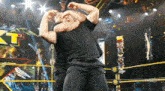 two men are wrestling in a ring with a sign that says nxt