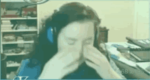 a person wearing headphones is covering their face