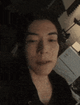 a close up of a person 's face in a dark room .