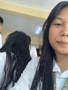 a girl wearing a lanyard that says ' philippines ' on it smiles for the camera