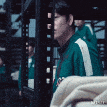 a man in a green shirt with the number 32 on the front