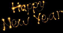 the word happy new year is written in sparklers on a black background