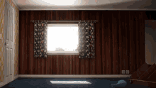 an empty room with a window and a blue balloon