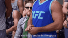 a man wearing a blue ufc jersey is sitting in a crowd