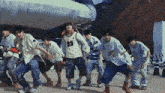 a group of young men are dancing and one of them is wearing a jersey with the number 83 on it