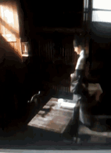 a blurred image of a person sitting at a table