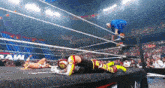 a wrestler in a ring with the word expert on his pants