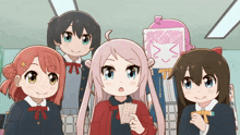 a group of anime girls standing next to each other with one girl holding a card