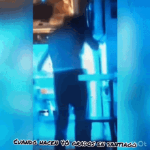 a man is standing in front of a blue light with the words cuando hacen yo grados en santiago written on the bottom