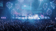 a large crowd of people are watching a band on stage