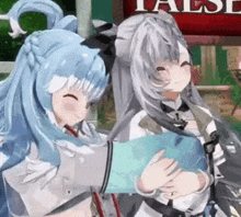 two anime girls are hugging each other in front of a false sign