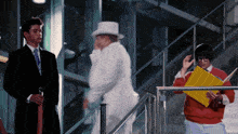 a man in a suit and tie stands next to a man in a top hat