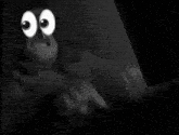 a close up of two cartoon eyes on a black background .