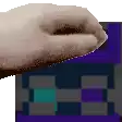 a close up of a person 's hand on a purple and black checkered background .