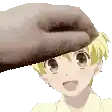 a hand is touching the head of a young boy .