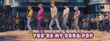 a group of people are dancing with the words you 're my soda pop below them