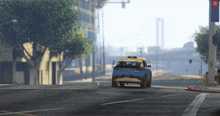 a blue and yellow car is driving down the street