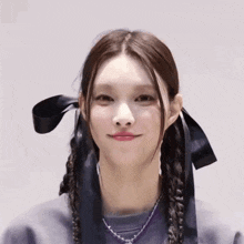a girl with braids and a ribbon around her head