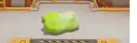 a group of stuffed animals are playing a video game with a green gummy bear in the middle ..