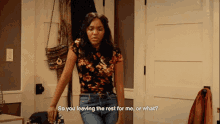 a woman in a floral shirt is standing in a room and says so you leaving the rest for me or what
