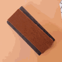 a person is holding a brick in their hands .