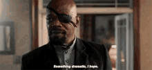 a man with a bandage on his eye is talking to someone .