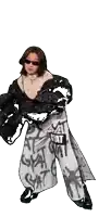 a woman wearing sunglasses and a black jacket is standing in front of a sign that says gyar