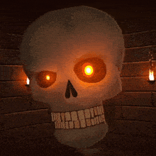 a cartoon skull with glowing eyes and teeth on a brick wall