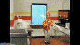 a man in a red and yellow shirt is dancing in a restaurant