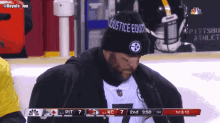 a man wearing a black hat that says " justice equates "