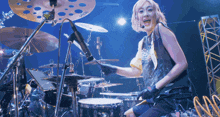 a woman is playing drums and wearing a shirt that says ' i 'm a freak ' on it
