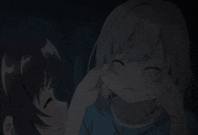 a girl with gray hair is being comforted by another girl in a dark room