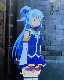 a girl with blue hair is standing in front of a wall