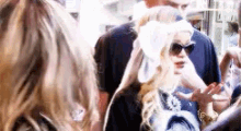 a group of people are standing next to each other in a crowd .