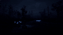 a dark night scene with a few lights shining in the water