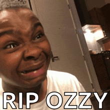 a man is making a funny face with the words rip ozzy behind him