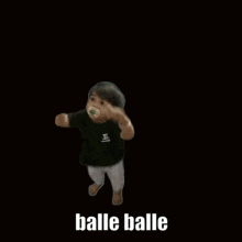 a baby is standing on a bed with the words " balle balle " written on the bottom