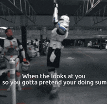 a storm trooper is hanging upside down in a parking lot
