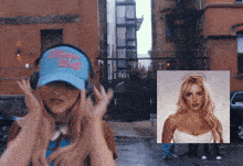 a woman wearing headphones and a blue hat has a picture of britney spears next to her