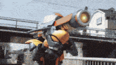 a robot is flying over a bridge with a green light coming out of its mouth