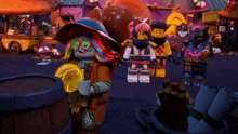 a group of lego figures are standing around a barrel