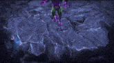 a green robot with purple gloves and wings is sitting on the ground