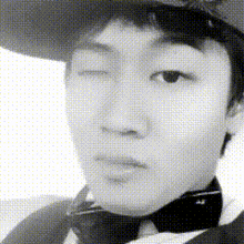 a black and white photo of a man wearing a cowboy hat